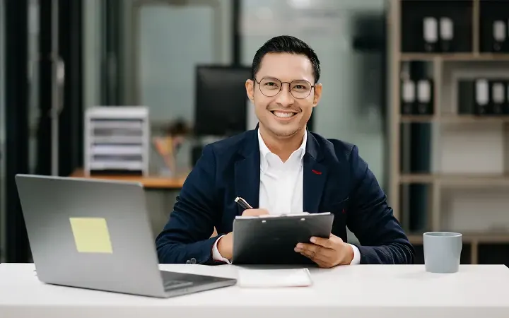 Professional reviewing automated processes on a laptop